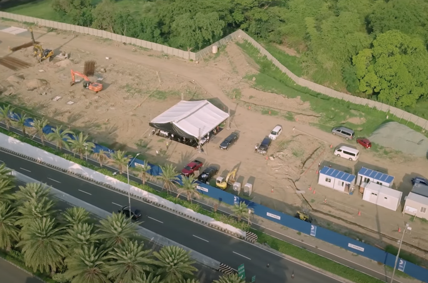 An aerial view of a large, rectangular area of dirt surrounded by trees.