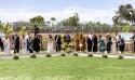 A line of people in Sunday best shoveling dirt.