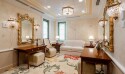 A bride's room in the Hong Kong temple, with white couches, wooden tables and a rug with a floral design.