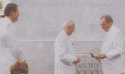 President Hinckley and President Monson wearing white suits and standing next to the cornerstone of the Kona Hawaii temple.