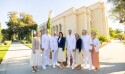 Elder Soares, Elder Mark A. Bragg and Elder James R. Rasband wearing all white and standing with their wives in front of the Feather River temple.